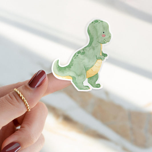 Person hält Sticker Dinosaurier Tyranno, handgemalt, langlebig, spritzfest. Perfekt für Bullet Journals oder Kindergeburtstage. Ideal für Dino-Fans jeden Alters. Größe: ca. 6 x 4,5 cm.