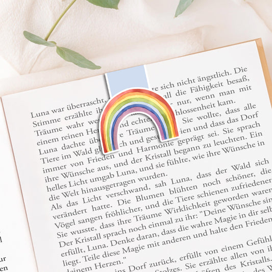 Magnetisches Lesezeichen Regenbogen blau: Handgemaltes Regenbogenmotiv auf mattem Papier, versiegelt mit Vinyl, mit Magneten zum sicheren Halt auf Buchseiten.