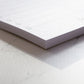 Nahaufnahme eines To-do Listen Blocks im DIN lang Format mit 50 abreißbaren Blättern aus cremefarbenem Naturpapier.