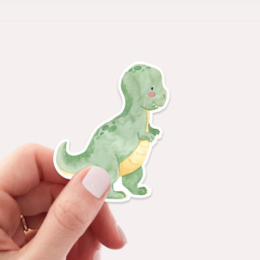 Hand hält Sticker Dinosaurier Tyranno, ein hochwertiger, langlebiger Vinyl-Aufkleber, ideal für Bullet Journals, Laptops oder Handyhüllen. Perfekt für Dino-Fans.